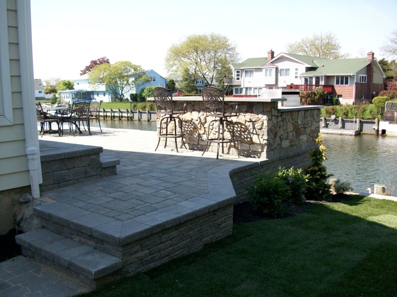 techo bloc paver patio with outdoor kitchen waterfront